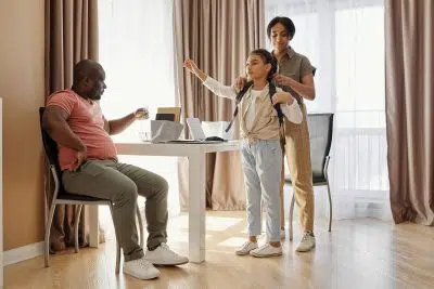 Parents Helping their Daughter to get Ready for School