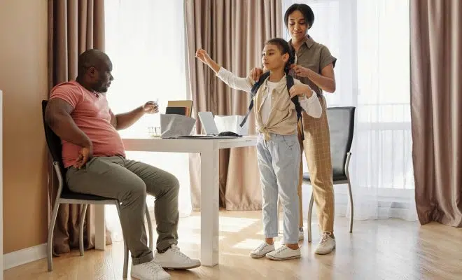 Parents Helping their Daughter to get Ready for School