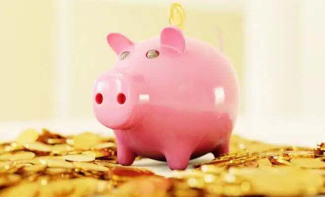 pink pig coin bank on brown wooden table