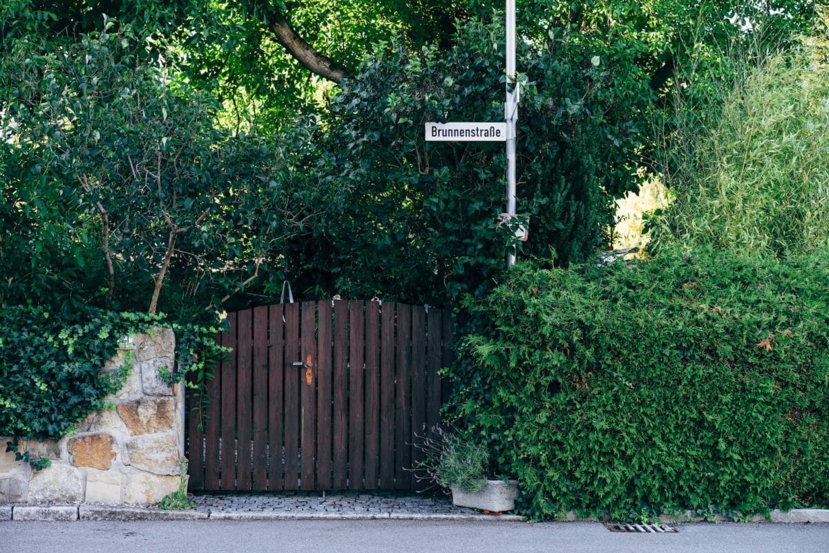 a wooden gate with a sign on it